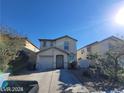 Two-story house with attached garage and landscaped front yard at 4202 Mango Tree Ct, Las Vegas, NV 89115