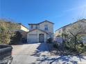 Two-story house with attached garage and landscaped front yard at 4202 Mango Tree Ct, Las Vegas, NV 89115