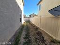 Side yard with gravel and a tall privacy fence at 4202 Mango Tree Ct, Las Vegas, NV 89115