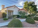 Single-story house with red tile roof, landscaping, and a walkway at 5400 Paul Kurtz Way # 102, Las Vegas, NV 89108
