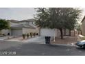 Two-story house with a large tree and two-car garage at 5987 Stone Hollow Ave, Las Vegas, NV 89156