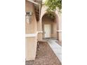 Front entrance with arched entryway and walkway at 5987 Stone Hollow Ave, Las Vegas, NV 89156