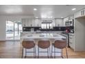 Modern kitchen with island, white cabinets, and stainless steel appliances at 6220 Carl Ave, Las Vegas, NV 89108