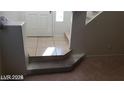 Home entryway with tiled floor and stairs leading upstairs at 6684 Coronado Crest Ave, Las Vegas, NV 89139