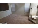 Spacious living room with neutral carpet and a staircase at 6684 Coronado Crest Ave, Las Vegas, NV 89139