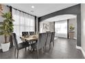 Elegant dining room features a large table with gray velvet chairs and stylish decor at 1204 Airborne Ct, North Las Vegas, NV 89032