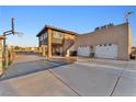 Two-story home featuring a large driveway, basketball hoop, well-kept landscaping, and a two-door garage at 12745 Fairfield Ave, Henderson, NV 89044