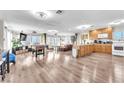 Open concept living space with a foosball table, wood-burning stove, a large window overlooking sunny views, and a kitchen at 12745 Fairfield Ave, Henderson, NV 89044