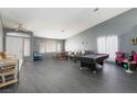 Bright living room with pool table, and ample natural light at 207 Charter Oak St, Henderson, NV 89074