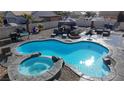 Inviting freeform pool with a spa and ample surrounding patio space at 2142 Seattle Shore St, Las Vegas, NV 89115