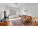 Living room featuring a leather sectional and a large window at 3125 N Buffalo Dr # 2136, Las Vegas, NV 89128