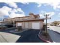 Beautiful two-story exterior showcasing well-maintained landscaping, a two-car garage, and a community street sign at 6701 Dorita Ave # 201, Las Vegas, NV 89108