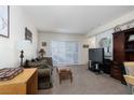 Cozy living room featuring a plush sofa, entertainment center, and sliding door leading to an outdoor space at 6701 Dorita Ave # 201, Las Vegas, NV 89108