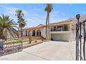 Luxury home with gated entrance and large driveway, desert setting at 672 Los Feliz St, Las Vegas, NV 89110