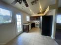 Kitchen with dark wood cabinets, granite countertops, and stainless steel appliances at 7555 Glowing Ember Ct # 201, Las Vegas, NV 89130
