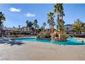 Resort-style pool area with rock features and palm trees, offering a luxurious outdoor experience for residents at 1701 King James St # 101, Las Vegas, NV 89144