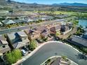 Aerial view of house and neighborhood with lake at 25 Via Corvina, Henderson, NV 89011