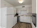 Updated kitchen featuring stainless steel appliances and wood flooring at 350 E Desert Inn Rd # H208, Las Vegas, NV 89109