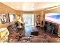 Living room with hardwood floors, large TV, and comfortable seating at 3550 Bay Sands Dr # 1070, Laughlin, NV 89029
