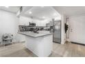 Modern kitchen with white cabinets, gray countertops, and stainless steel appliances at 4071 Village Sq, Las Vegas, NV 89121