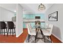 Kitchen and dining area with light-colored cabinets and glass table at 4380 Sandy River Dr # 36, Las Vegas, NV 89103