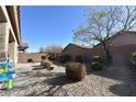 Landscaped backyard with gravel and desert plants at 6119 Forest Pony Ave, Las Vegas, NV 89122