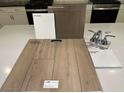 Selection of home interior finishings including vinyl plank, countertops, fixtures, and cabinet style at 6592 Tumoulin St, Las Vegas, NV 89148
