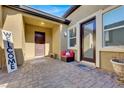 Inviting front courtyard with paver stones, a comfortable sitting area, and a welcoming sign at 7036 Winstar St # A, Las Vegas, NV 89131