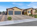 Three-car garage and gated driveway leading to a lovely single story house at 7036 Winstar St # A, Las Vegas, NV 89131