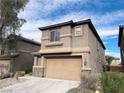 Two-story house with tan siding, a large garage, and landscaping at 764 Crest Valley Pl, Henderson, NV 89011