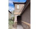 Front entrance with stone accents and a dark brown door at 764 Crest Valley Pl, Henderson, NV 89011