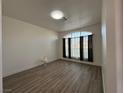 Spacious living room with large window and wood-look flooring at 8545 Summer Vista Ave, Las Vegas, NV 89145