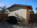 Tan shed with grill and outdoor storage in backyard at , North Las Vegas, NV 89031