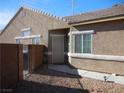 Side view of house with light tan exterior and security door at , North Las Vegas, NV 89031