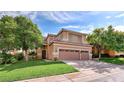 Two-story house with a two-car garage and American flag at 316 Pleasant Summit Dr, Henderson, NV 89012