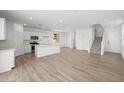 Spacious living room with hardwood floors, white walls, and a modern kitchen area. Lots of natural light at 334 Taylor St, Henderson, NV 89015
