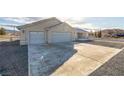 Three-car garage and expansive gravel driveway in front of house at 5181 Sumpter Ct, Pahrump, NV 89061