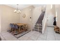 Dining area with wooden table and staircase view at 6301 Beavertail Pond Ave, Las Vegas, NV 89122