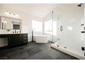 Spa-like bathroom with freestanding tub, walk-in shower, and dark vanity at 6436 Heatherton Ave, Las Vegas, NV 89110