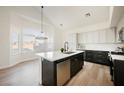 Modern kitchen with island, stainless steel appliances, and white cabinets at 6436 Heatherton Ave, Las Vegas, NV 89110