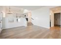 Light and airy living room with hardwood floors and a view to the kitchen at 6436 Heatherton Ave, Las Vegas, NV 89110