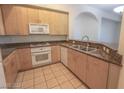 Modern kitchen with granite countertops and stainless steel appliances at 68 E Serene Ave # 112, Las Vegas, NV 89123