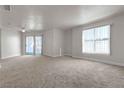 Bright living room featuring carpet, large windows, and a ceiling fan at 6800 E Lake Mead Blvd # 2028, Las Vegas, NV 89156