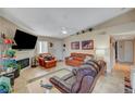 Living room with brown leather furniture and a fireplace at 1575 W Warm Springs Rd # 1423, Henderson, NV 89014