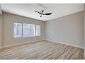 Bright living room with light wood flooring and a ceiling fan at 1894 Wallingford St, Henderson, NV 89052