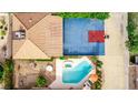 Detailed aerial shot of a backyard featuring a pool, hot tub, and a full-sized basketball court at 2730 El Camino Rd, Las Vegas, NV 89146