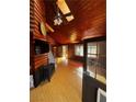 Cozy living room with wood-paneled walls and a wood-burning stove at 302 Kris Kringle Rd, Las Vegas, NV 89124