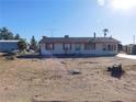 A one-story home on a large lot, featuring basic landscaping and desert surroundings at 3748 Skyline St, Logandale, NV 89021