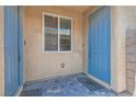 Front entry with blue door and brick flooring at 4104 Midnight Crest Ave, North Las Vegas, NV 89031