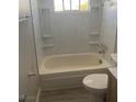 Clean bathroom with a bathtub, toilet, and updated vanity at 4745 E Flamingo Rd, Las Vegas, NV 89121